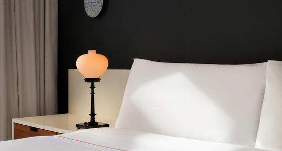 bed and bedside table with lamp
