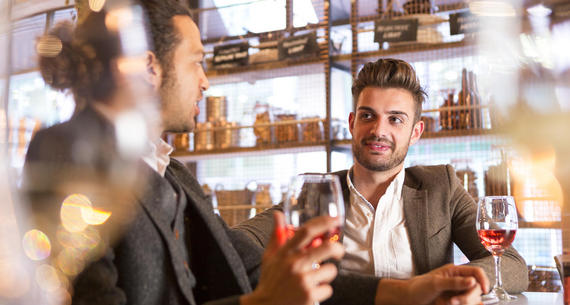 men talking at a bar